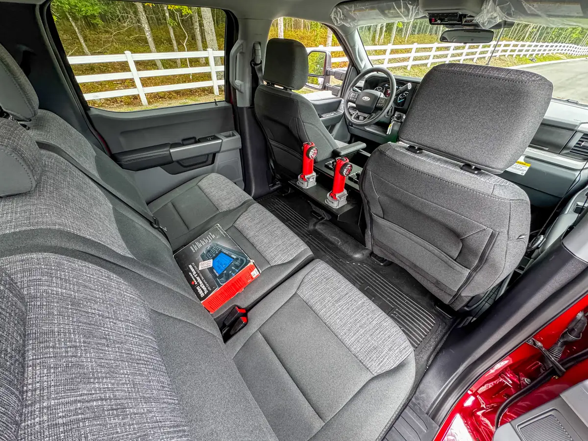 Rear cabin view showing bench seat, side trim, and floor area.